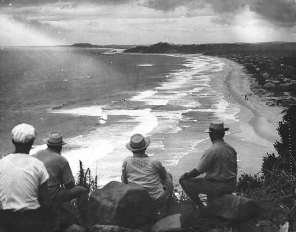 Four men looking out at the sea, Gold Coast, Australia, 1949