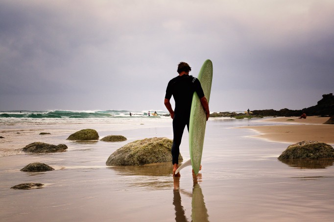 Surfer heading out