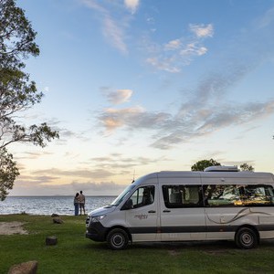 Mighty Deuce Plus AU Camper and Couple at Lakeside Sunset