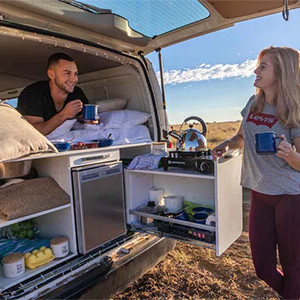 Jucy Compass Campervan – 4 Berth-couple-making-tea-laughing-at-back-of-compass