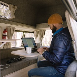 Mighty HiLITE AU Man Using Laptop at Rear Table