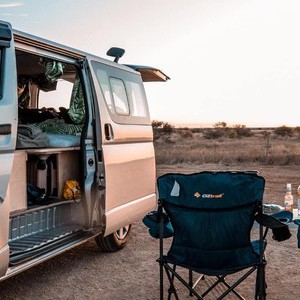 HR – 2-3 Berth Camper beside Campsite Chairs at Sunset HR – 2-3 Berth Camper beside Campsite Chairs at Sunset